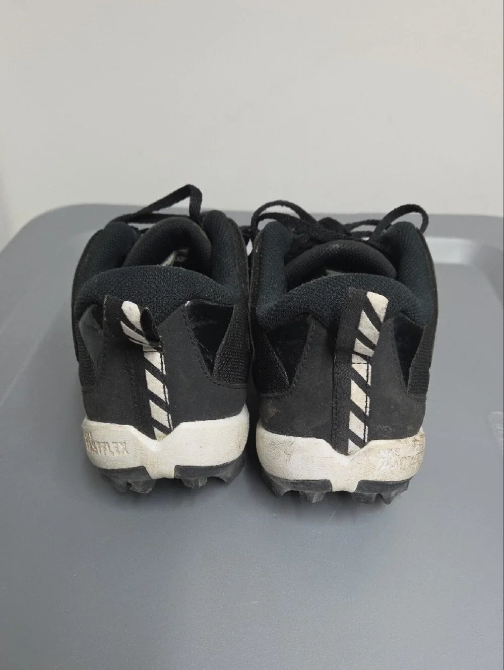 Nike Black and White Youth Athletic Cleats with Yellow Studs